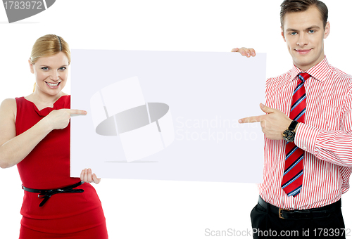 Image of Business colleagues pointing at blank signboard