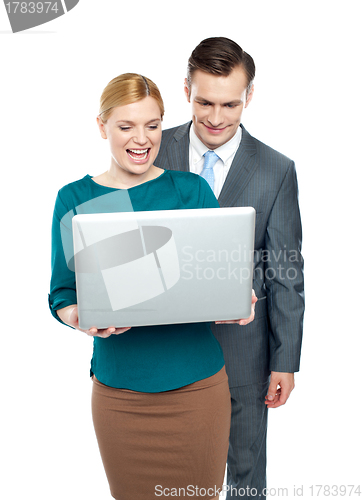 Image of Business people enjoying funny videos on laptop
