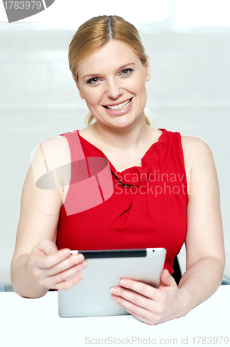Image of Beautiful young woman holding portable tablet pc