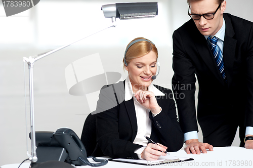 Image of Young business people reading documents