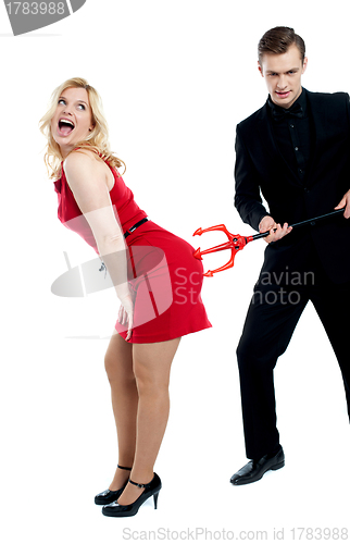 Image of Evil guy poking sensual woman in red