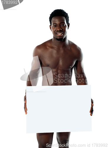 Image of Naked black man holding blank billboard