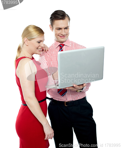 Image of Office workers holding a laptop