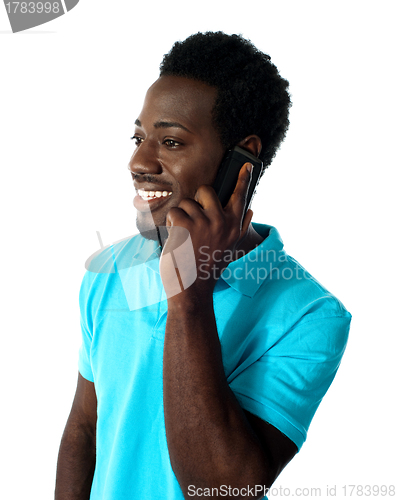 Image of African guy communicating via cellphone