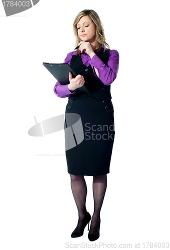 Image of Corporate woman reading official documents