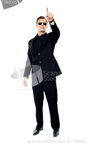Image of Young handsome man pointing upwards