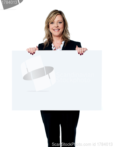 Image of Female executive showing an advertising board
