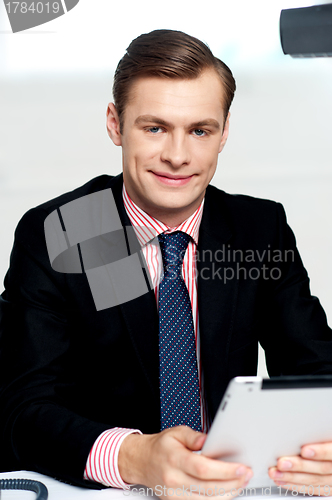 Image of Young executive posing with tablet pc