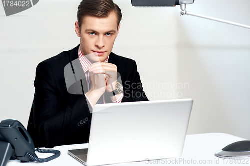 Image of Businessman sitting in front of laptop