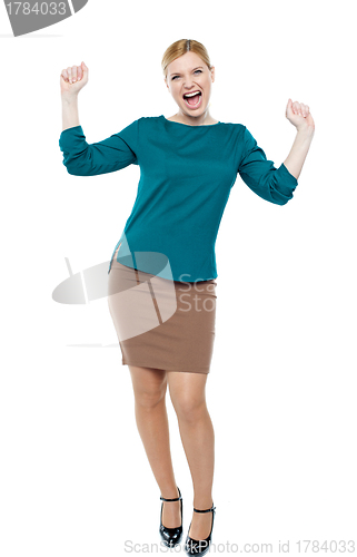 Image of Excited businesswoman celebrating success