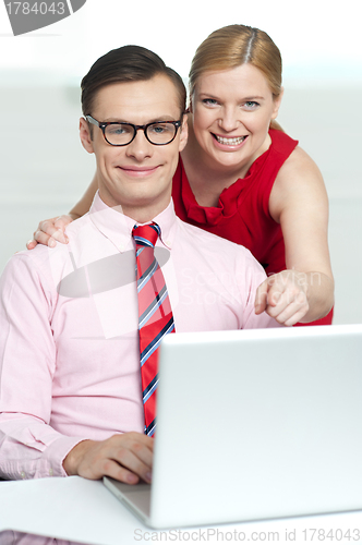 Image of Corporate couple enjoying videos on laptop