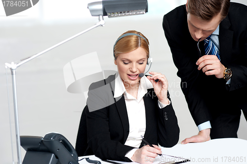 Image of Woman discussing problem with male colleague