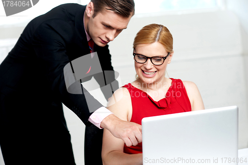 Image of Business team in action. Man pointing at laptop