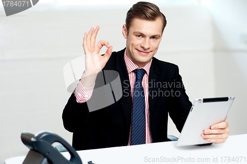 Image of Smiling corporate male showing ok sign