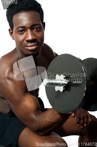 Image of Powerful young man lifting weights