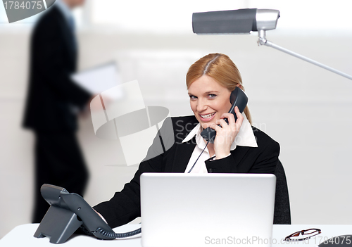 Image of Attractive secretary attending phone call