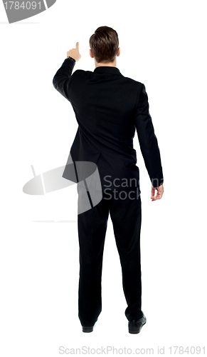 Image of Rear view of a male model pointing