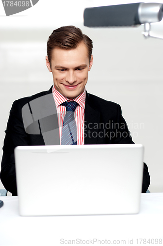 Image of Business male watching videos on laptop