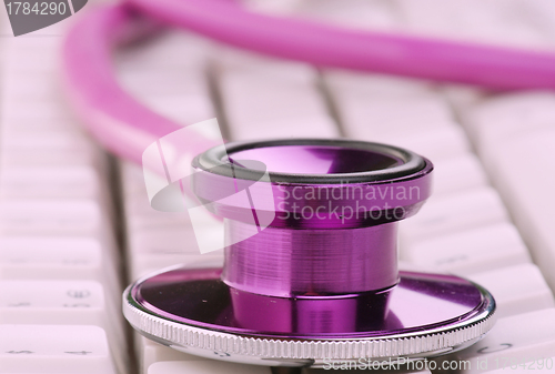 Image of pink stethoscope on keyboard