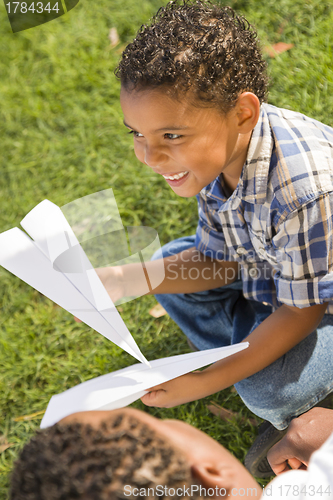 Image of Mixed Race Father and Son Playing with Paper Airplanes