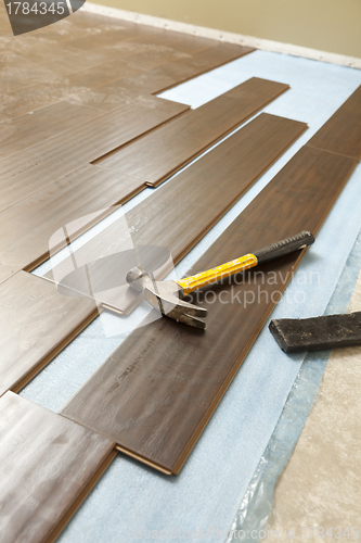 Image of Hammer and Block with New Laminate Flooring