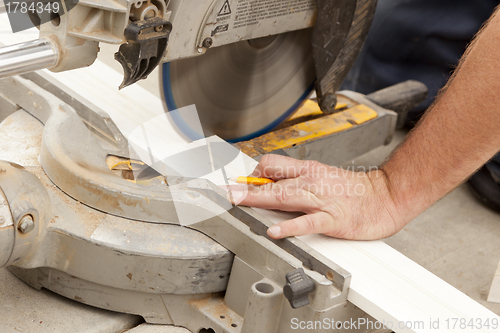 Image of Contractor Cutting New Baseboard for Renovation