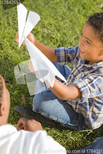 Image of Mixed Race Father and Son Playing with Paper Airplanes