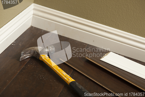 Image of Hammer, Laminate Flooring and New Baseboard Molding