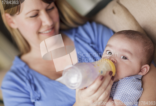 Image of Happy Mother Bottle Feeding Her Son