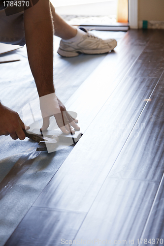 Image of Man Installing New Laminate Wood Flooring