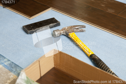 Image of Hammer and Block with New Laminate Flooring