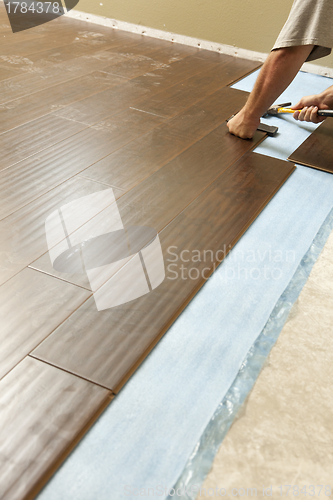 Image of Man Installing New Laminate Wood Flooring