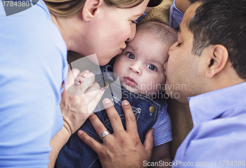 Image of Mixed Race Parent Kissing Their Son