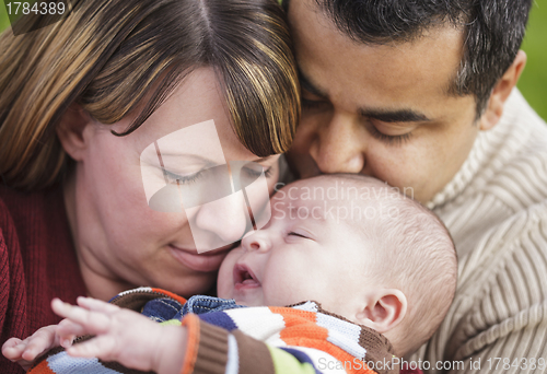 Image of Happy Mixed Race Parents Hugging Their Son