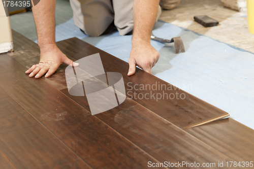 Image of Man Installing New Laminate Wood Flooring