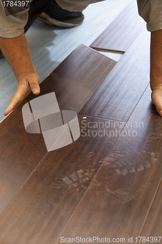 Image of Man Installing New Laminate Wood Flooring