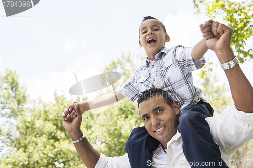 Image of Hispanic Father and Son Having Fun in the Park