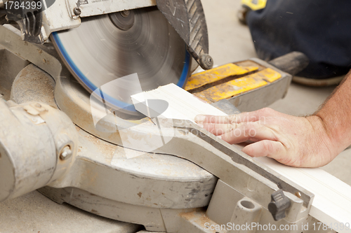 Image of Contractor Cutting New Baseboard for Renovation