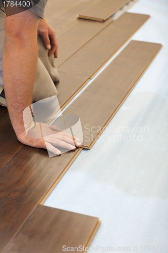 Image of Man Installing New Laminate Wood Flooring