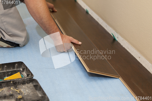 Image of Man Installing New Laminate Wood Flooring