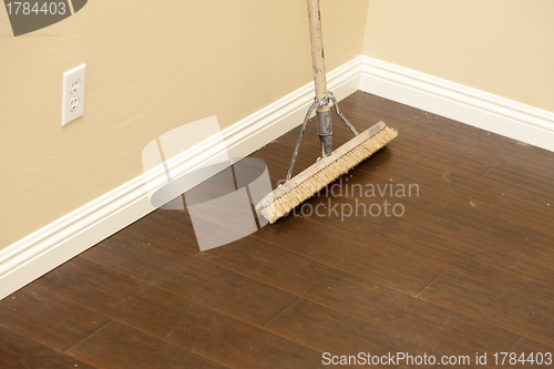 Image of Push Broom on a Newly Installed Laminate Floor and Baseboard