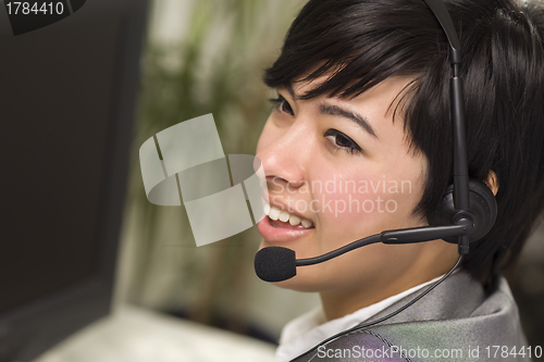 Image of Attractive Young Mixed Race Woman Smiles Wearing Headset