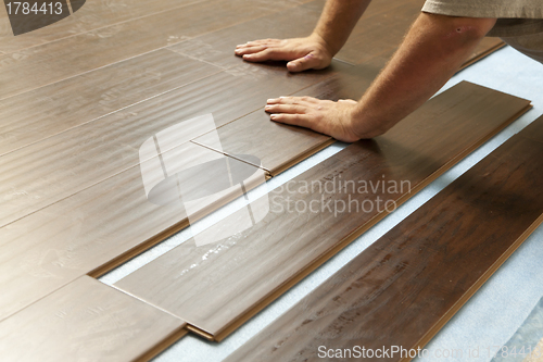 Image of Man Installing New Laminate Wood Flooring