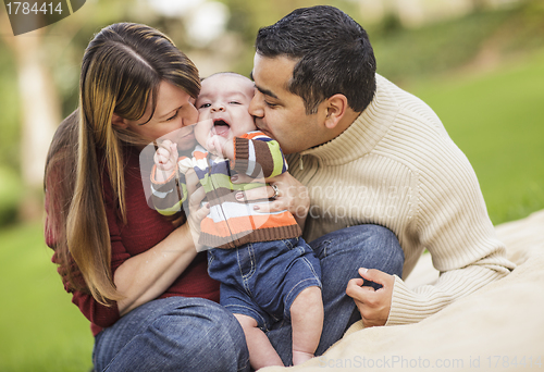 Image of Happy Mixed Race Parents Playing with Their Son