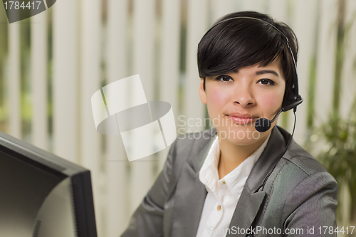 Image of Attractive Young Mixed Race Woman Smiles Wearing Headset