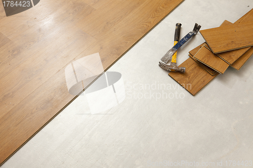 Image of Hammer and Pry Bar with Laminate Flooring Abstract