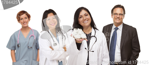 Image of Hispanic Female Doctor or Nurse with Baby Shoes and Support Staf