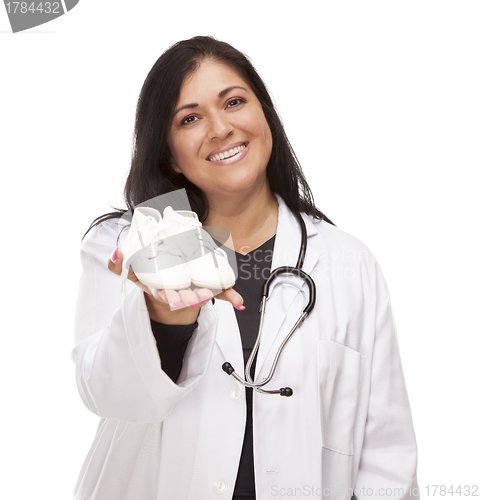 Image of Hispanic Female Doctor or Nurse with Baby Shoes on White