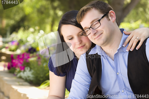 Image of Young Engaged Couple Relaxing in the Park
