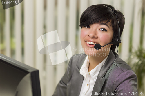 Image of Attractive Young Mixed Race Woman Smiles Wearing Headset